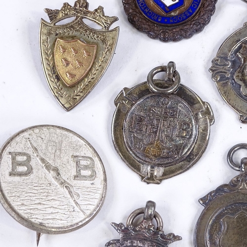 374 - A collection of silver fobs, including some enamel