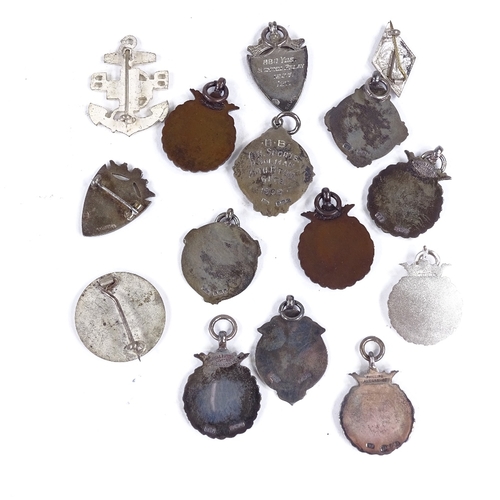 374 - A collection of silver fobs, including some enamel