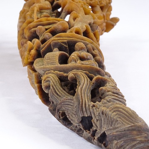 300 - A 19th century Chinese rhinoceros horn full tip cup, carved and pierced all over with Oriental figur... 