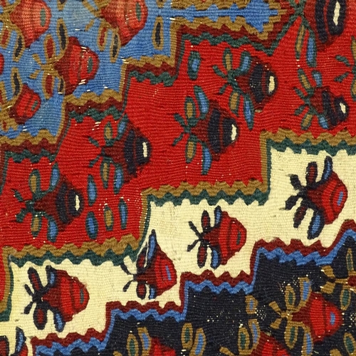 343 - A Kilim red and blue ground floral pattern rug