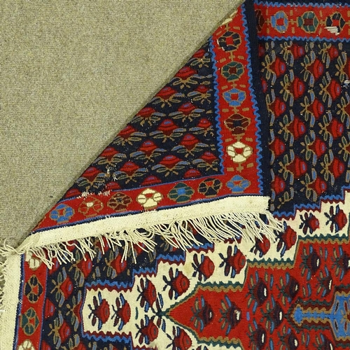 343 - A Kilim red and blue ground floral pattern rug