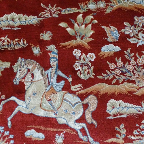 357 - A finely woven Middle Eastern red ground silk rug, depicting hunting scenes