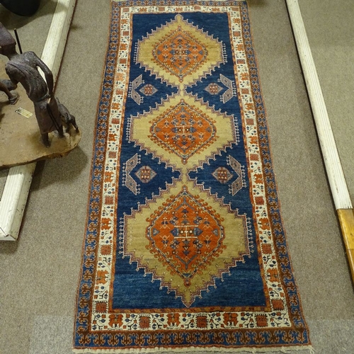 358 - A hand woven Persian red and blue ground wool rug