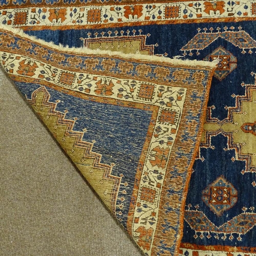 358 - A hand woven Persian red and blue ground wool rug