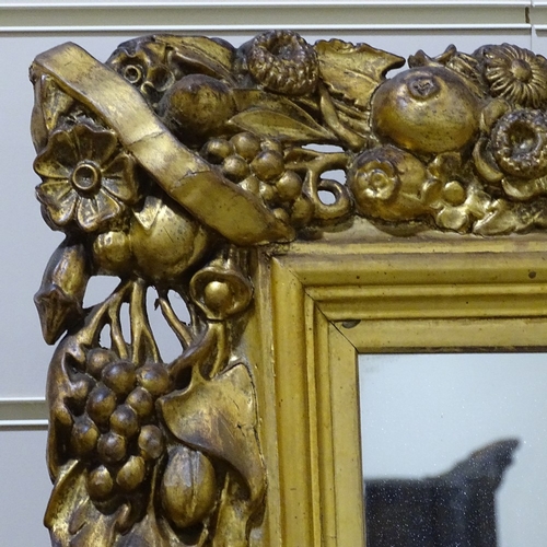 393 - A large Victorian gilt-gesso framed wall mirror, with fruit decorated surround, overall dimensions 9... 