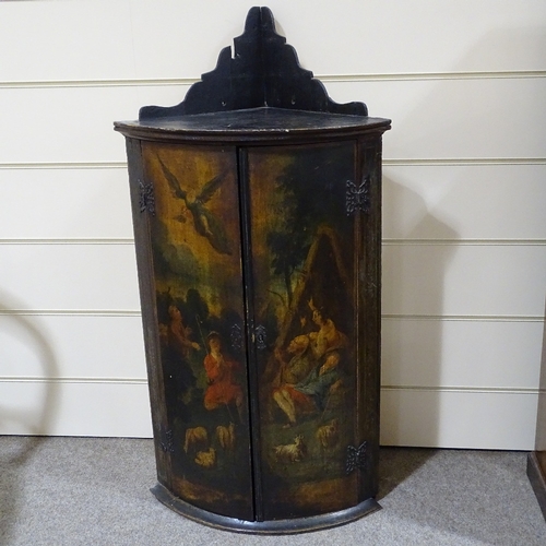 82 - A 19th century bow-front 2-door hanging corner cupboard, with painted religious scene, height to top... 