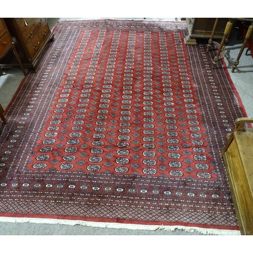 359 - A large Persian handmade red ground geometric design wool rug