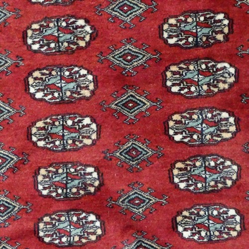 359 - A large Persian handmade red ground geometric design wool rug