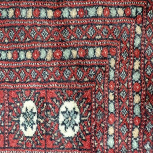 359 - A large Persian handmade red ground geometric design wool rug