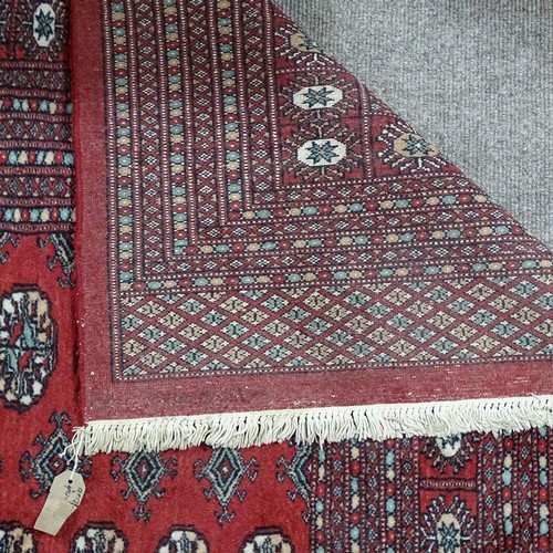 359 - A large Persian handmade red ground geometric design wool rug