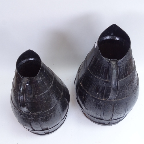 3 - A large graduated pair of black painted coopered oak water flagons, largest height 47cm