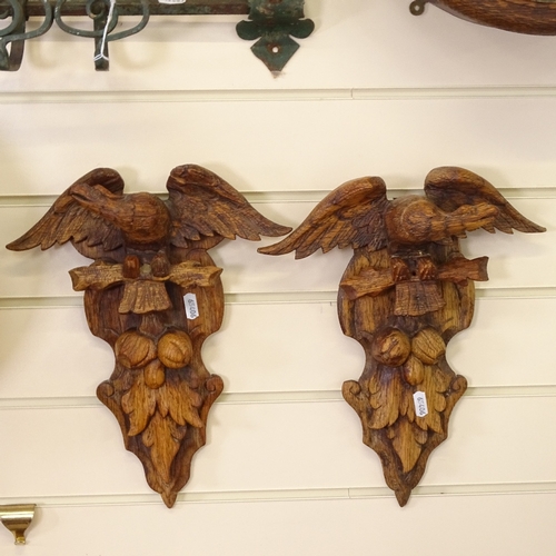 118 - An opposing pair of carved pine eagle wall brackets, height 33cm