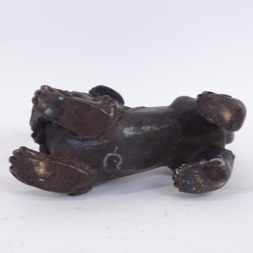 123 - An Oriental polished bronze Dog of Fo, length 16cm