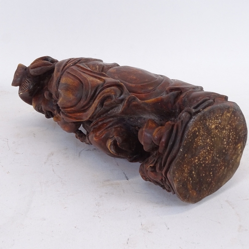 124 - An Oriental carved and stained wood Buddha figure, height 26cm