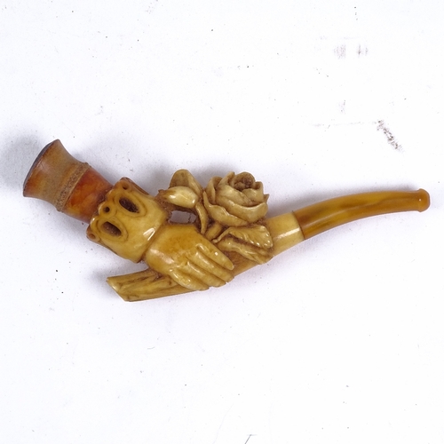 138 - WITHDRAWN A 19th century Meerschaum pipe, formed as a hand holding a rose with amber tips, length 12... 