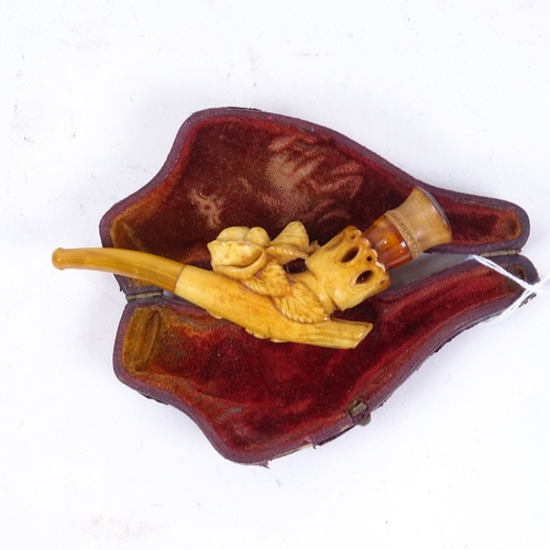 138 - WITHDRAWN A 19th century Meerschaum pipe, formed as a hand holding a rose with amber tips, length 12... 