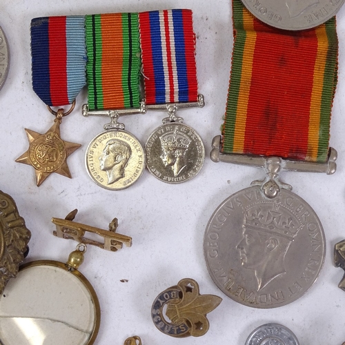 169 - Various Second War Defence and Campaign medals, military cap badges, brooches etc