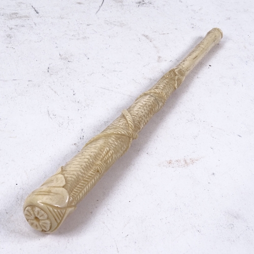 172 - A 19th century relief carved bone parasol handle, with tassel and rope decoration, length 24cm