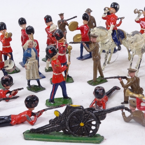 214 - A collection of Vintage painted metal soldiers, cowboys, guardsmen etc, some with impressed marks fo... 