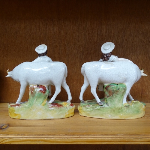 260 - A pair of Staffordshire porcelain figures, farmer and wife with cattle, height 18cm