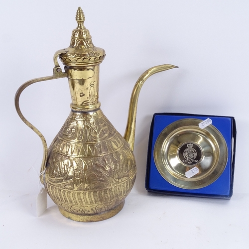 298 - An Islamic embossed brass wine ewer, and a Tower Mint Royal Geographical Soceity commemorative dish ... 