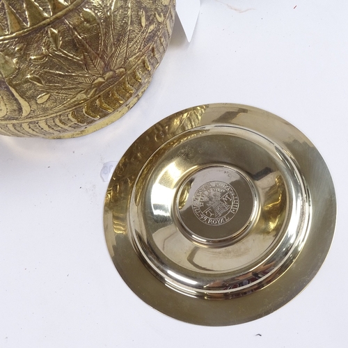 298 - An Islamic embossed brass wine ewer, and a Tower Mint Royal Geographical Soceity commemorative dish ... 