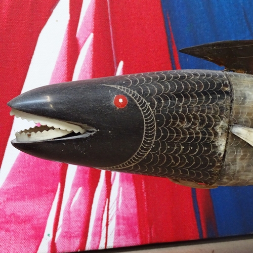 313 - A carved horn fish on stand, 49cm