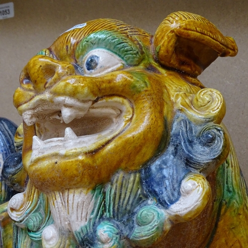 317 - A large Chinese treacle glaze terracotta Dog of Fo, length 40cm