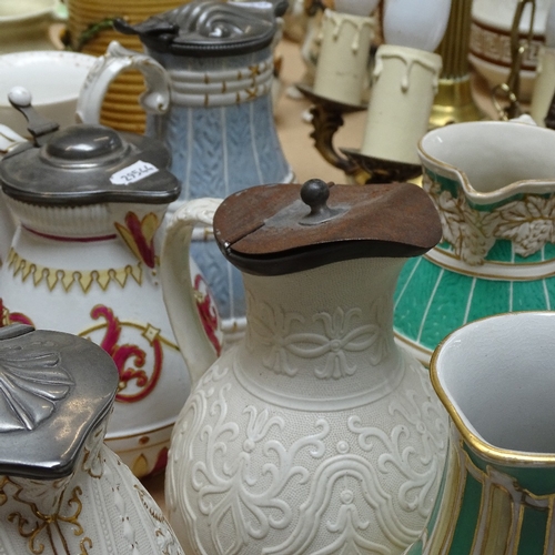 337 - A collection of 19th century embossed pottery jugs, some with pewter lids (11)