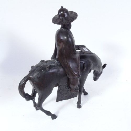 437 - An Oriental bronze figure of a horseman (in 2 parts), height 42cm