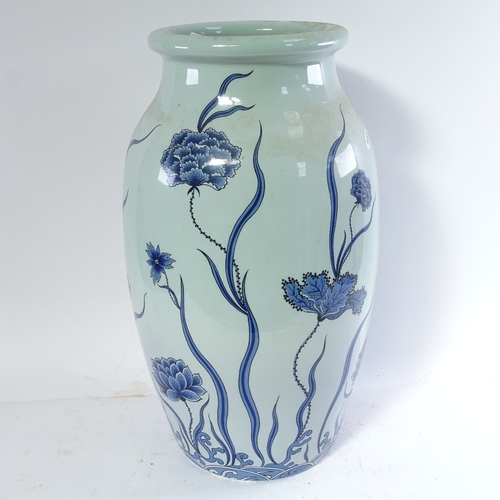 461 - A Chinese blue and white vase with floral decoration, 51cm