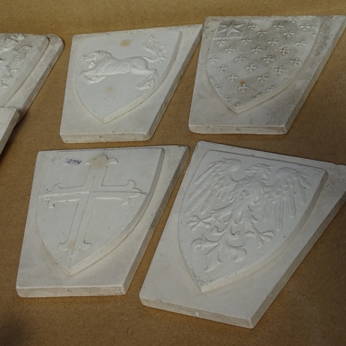 466 - 7 plaster heraldic plaques, largest 30.5cm, and a squirrel