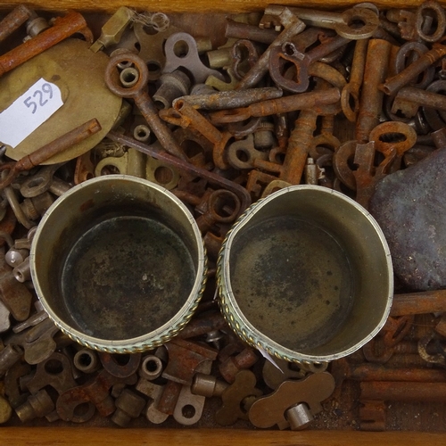 529 - A collection of Antique keys, an African cast-iron slave bangle, a pair of Chinese nickel and brass ... 