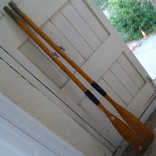 557 - A pair of stained pine boat oars