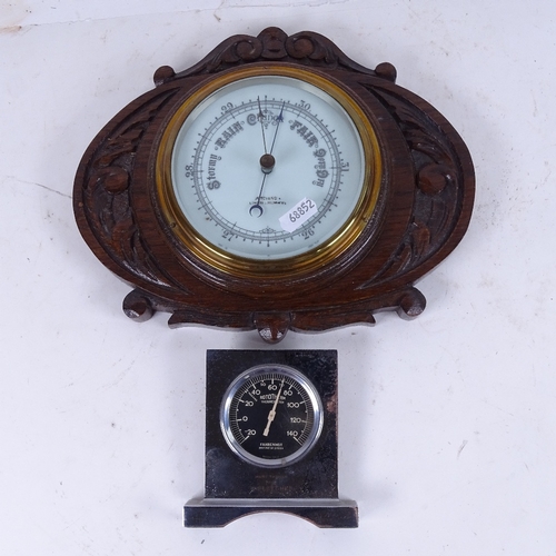 569 - An aneroid wall barometer in carved oak frame, and an Art Deco thermometer in chrome plate frame (2)