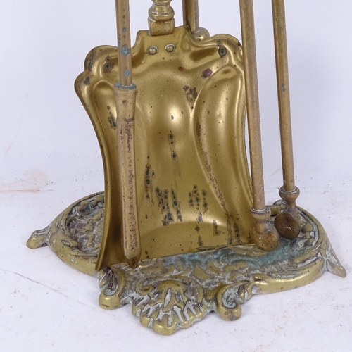 588 - A brass fire companion set on stand