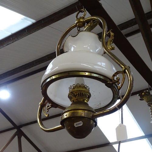 593 - A brass hanging lantern light fitting, with opaque glass shade, height 46cm