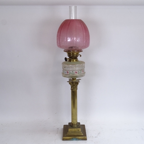 60 - A 19th century brass Corinthian column duplex oil table lamp, hand painted and gilded floral font wi... 