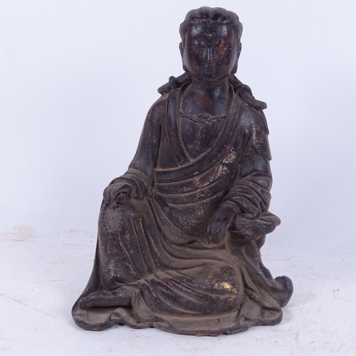 609 - An Oriental cast-iron Buddha with traces of gilding, 25cm