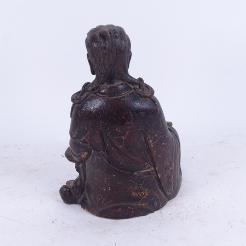 609 - An Oriental cast-iron Buddha with traces of gilding, 25cm