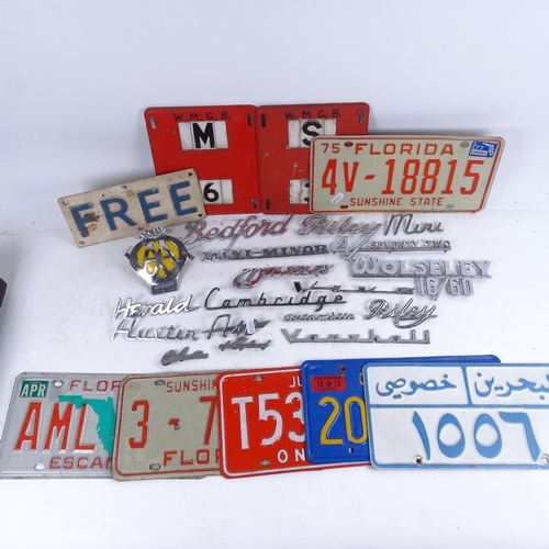 658 - Vintage American metal car number plates, chrome plated car model badges, an AA badge etc