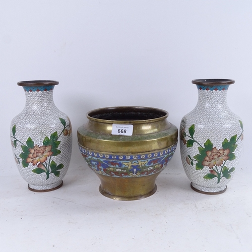 668 - A pair of cloisonne vases with floral spray decoration, 23cm, and a brass pot with enamelled frieze