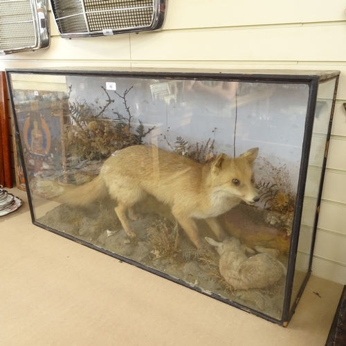 68 - TAXIDERMY - a hunting fox with rabbit, in naturalistic surround and glazed case, case length 115cm, ... 