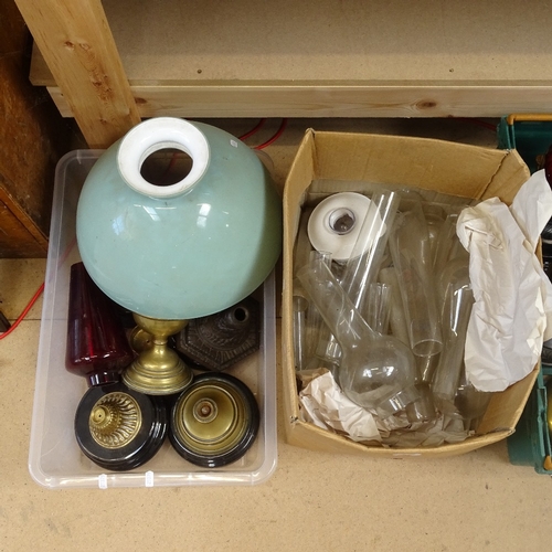 84 - A large collection of various oil lamp parts and spares, including shades, bases and chimneys (3 box... 