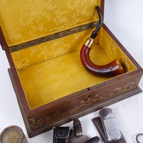 682 - Cased pipes, matches, lighter, in a decorative gilded box with brass plaque, 26cm across