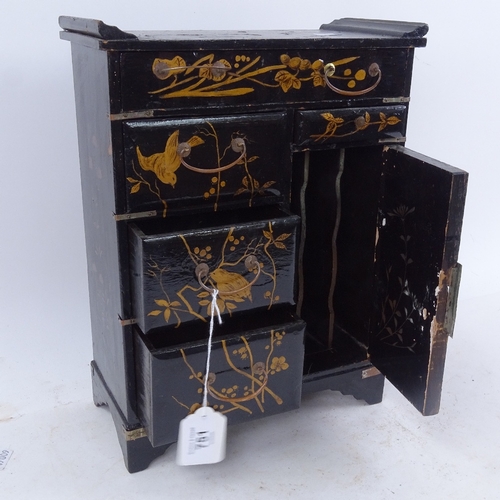 751 - An Oriental table-top lacquered and gilded cabinet, with inset porcelain panel to the door, height 3... 