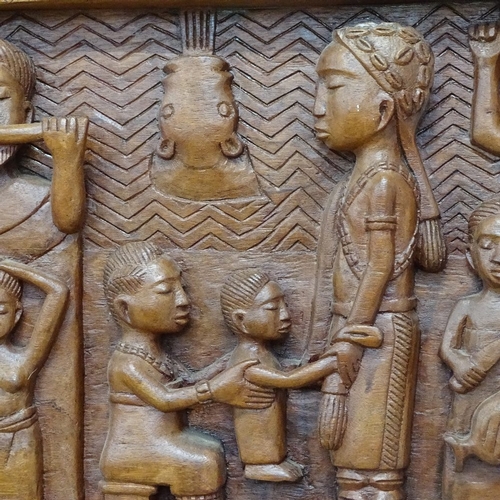 754 - A carved wood frieze depicting African musicians and family, length 1m