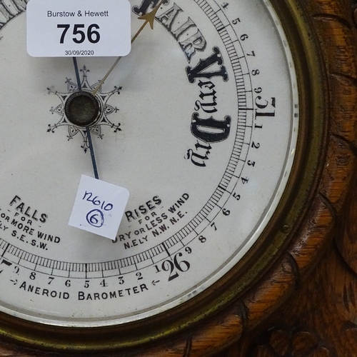 756 - A Victorian carved oak-cased aneroid wall barometer, with inset clock, ceramic dials and carved anch... 