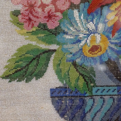 762 - A framed beadwork study of a vase of flowers, 40cm x 32cm overall