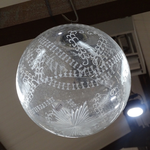 809 - A globular glass lamp shade with engraved decoration, 25cm diameter approx